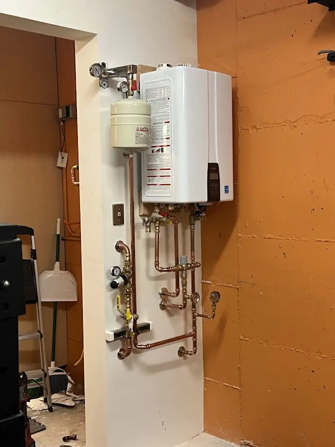 Plumbing technician inspecting water heater connections in Centralia